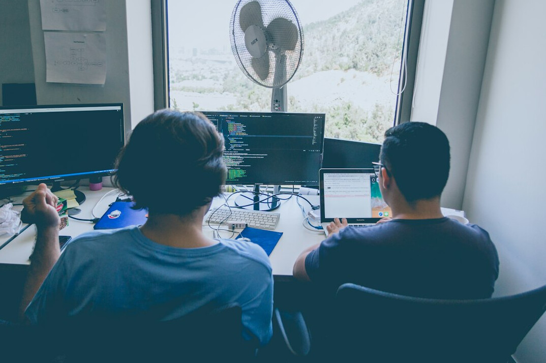 students coding together in class