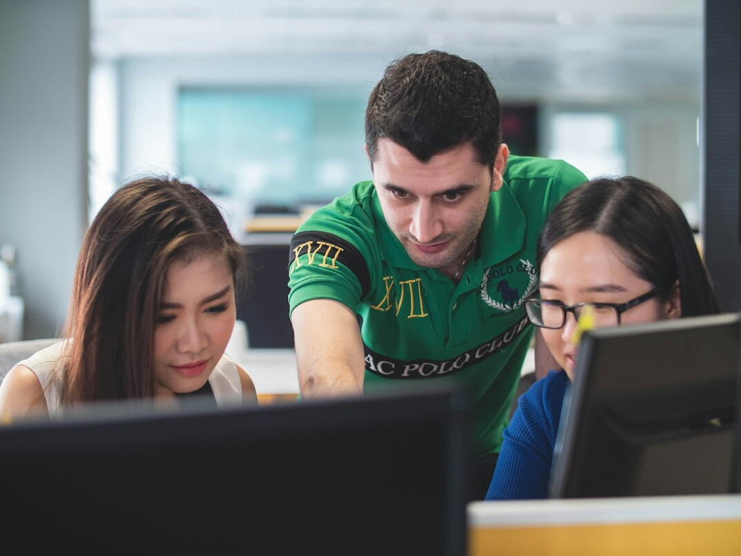 group of students discussing code