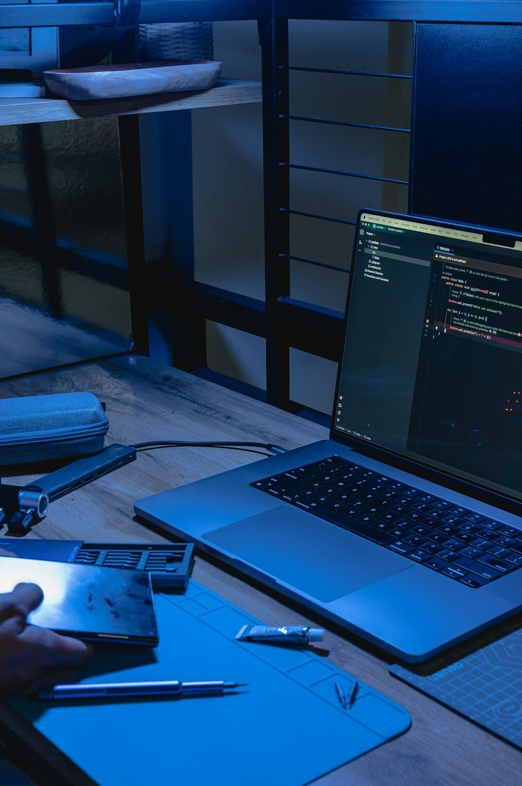 person writing code on laptop
